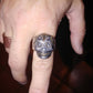 silver day of dead ring worn on finger