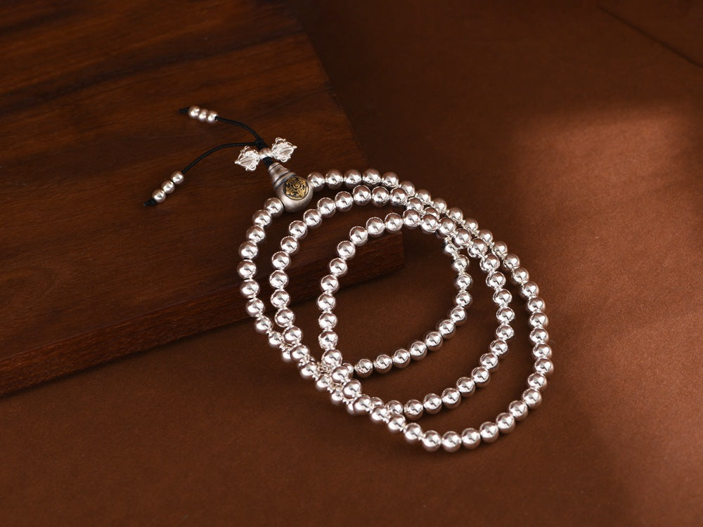 silver prayer beads laid flat for display