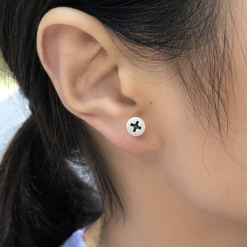 silver screw earrings on ear