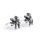 silver spider earrings on white background side view