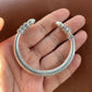 silver tibetan engraved heart sutra bangle bracelet on palm
