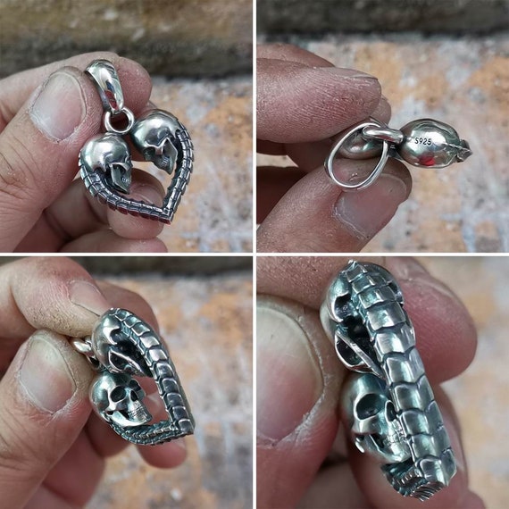 skull heart necklace held in hand showing details different views