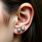 small cat earrings worn on ear lobe close up