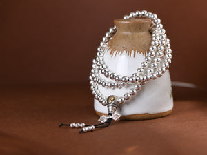 sterling silver mala beads arranged in loop