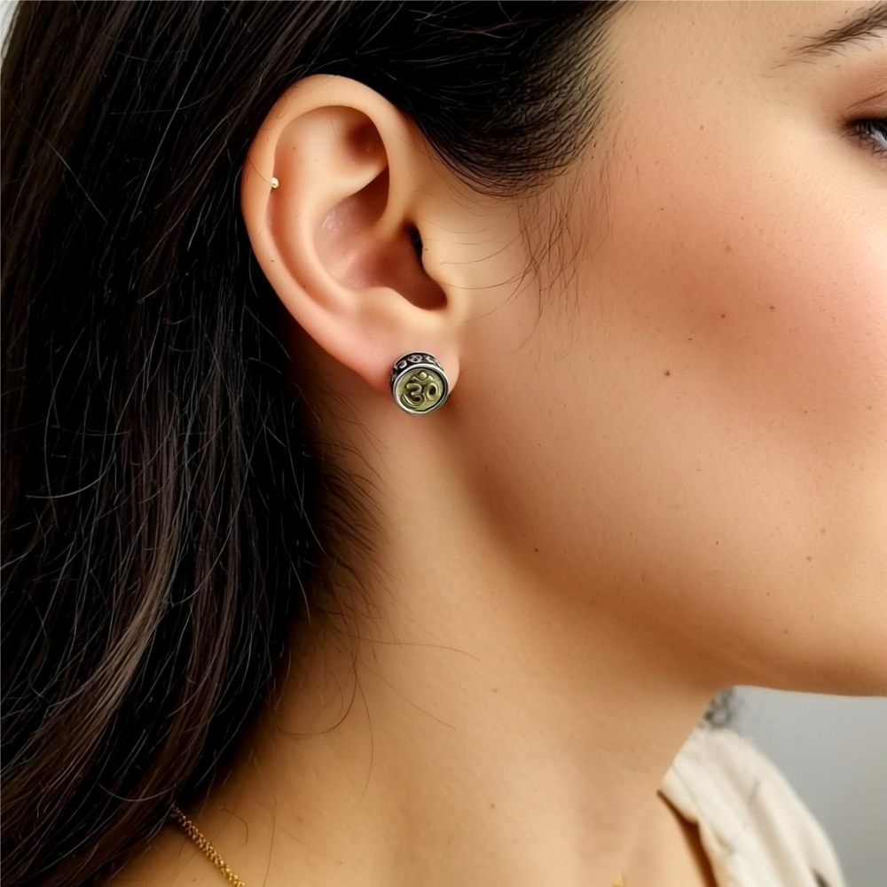 sterling silver om earrings on ear close up