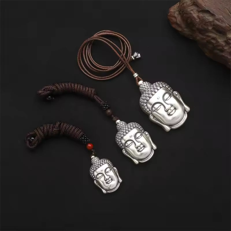 three silver buddha pendants side by side