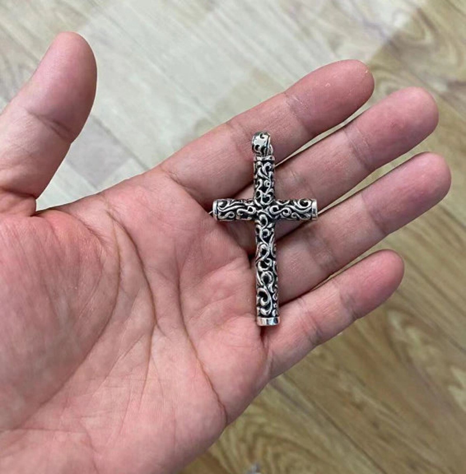viking cross pendant on hand