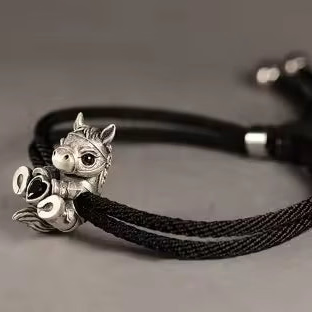 vintage style silver horse charm on black rope bracelet
