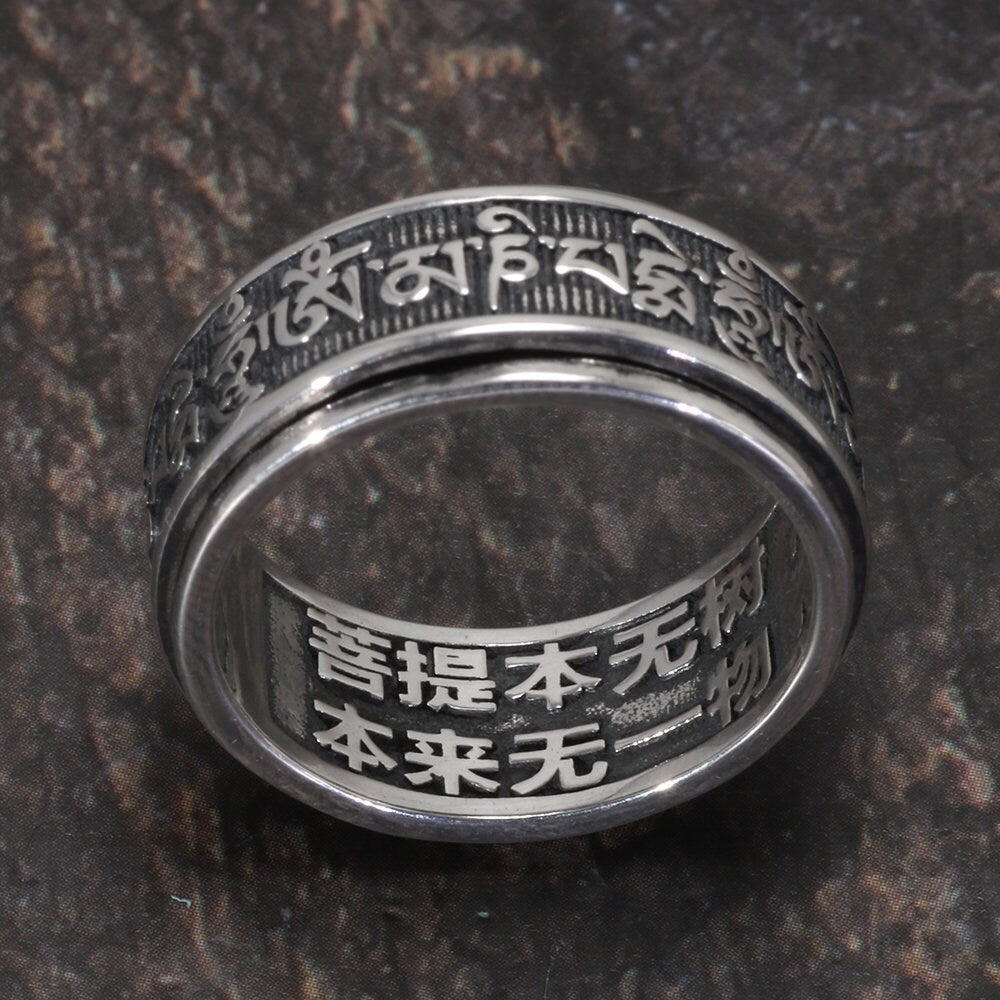 Buddhist Sanskrit spinner ring close up