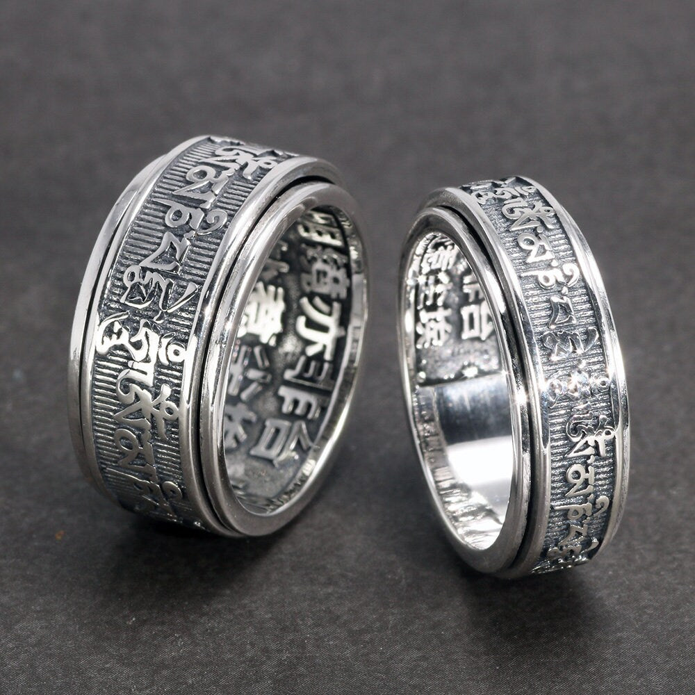 Buddhist meditation ring finger close up showing Sanskrit engraving